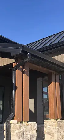 Germantown Seamless Guttering & Siding recent project - new house with rock facade, vertical siding and new guttering - Clinton County, IL