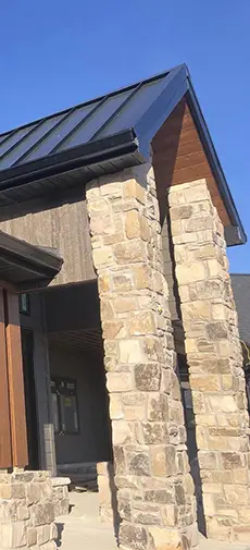 Germantown Seamless Guttering & Siding recent project - new house with rock facade, vertical siding and new guttering - Clinton County, IL
