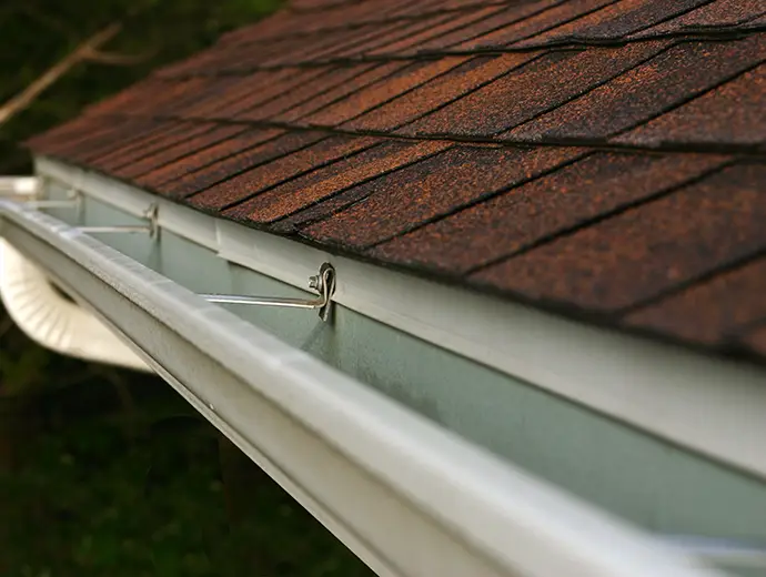 Close view of residential guttering system on roof - Clinton County, IL