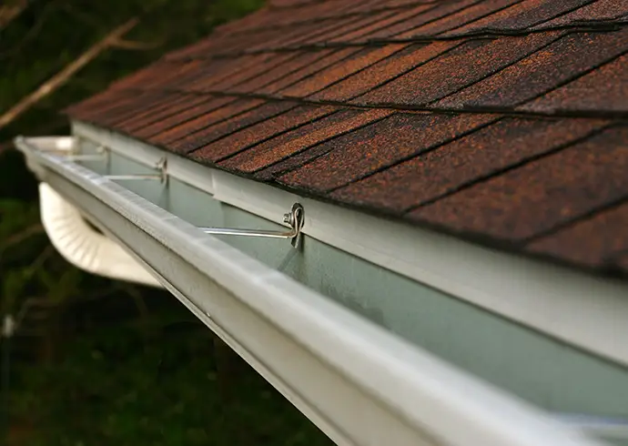 Close view of residential guttering system on roof - Clinton County, IL